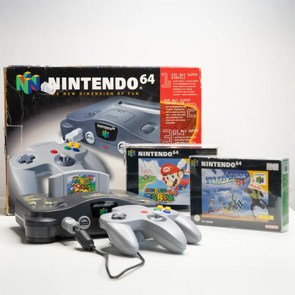 Nintendo 64 Konsole beim Deutschlandstart mit Originalverpackung, Controller und Launch-Titeln wie Super Mario 64 und Pilotwings 64